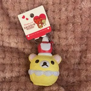 Squishy San toy pastel yellow bear w red hat pink ears brown eyes keychain nwt
